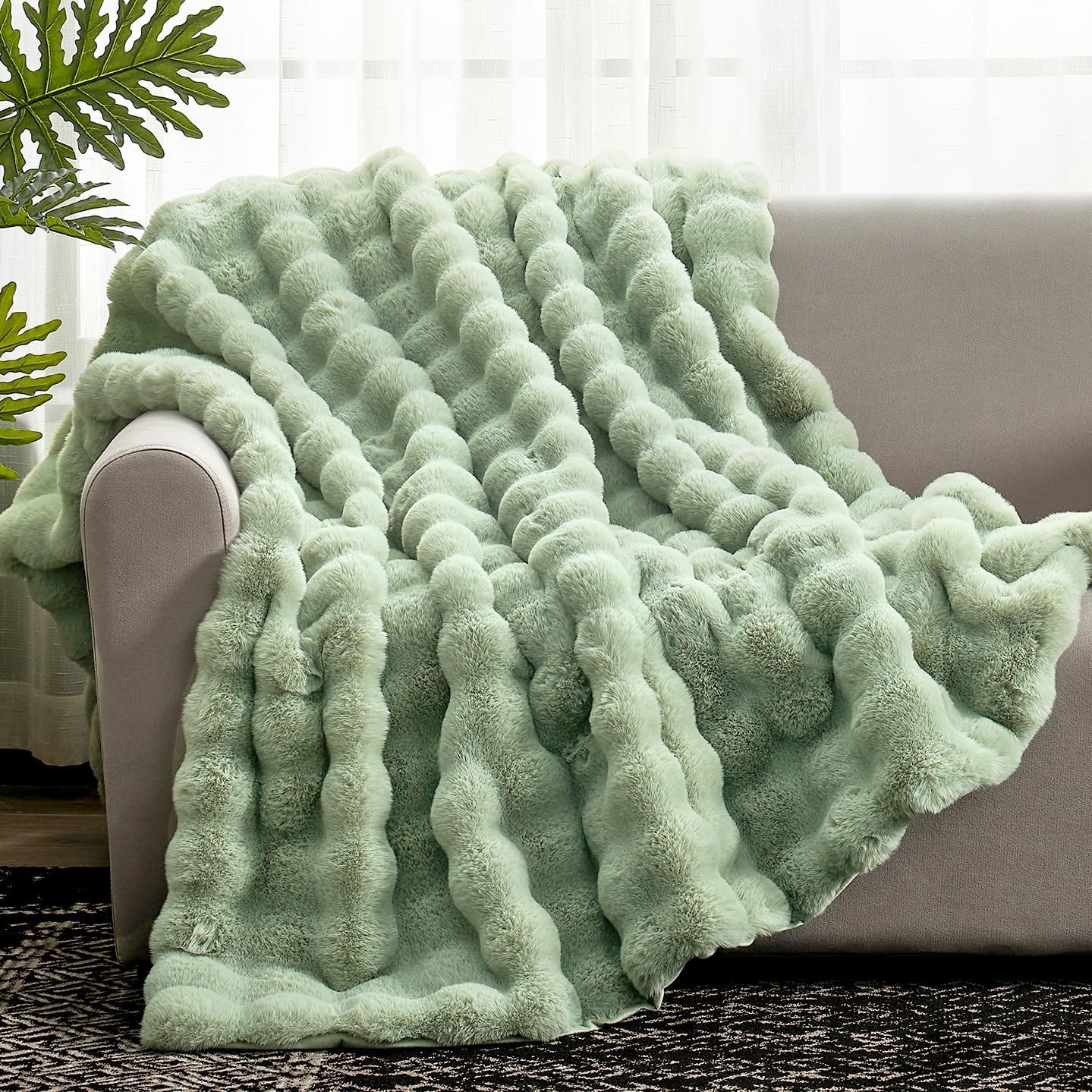 Cozy Bliss faux fur throw blanket in sage green on couch delivers cozy warmth