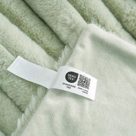 Cozy Bliss faux fur throw blanket wrapped on chair for easy coziness.
