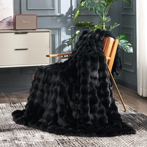 Cozy Bliss faux fur throw with bubble design adds stylish warmth to a sofa.