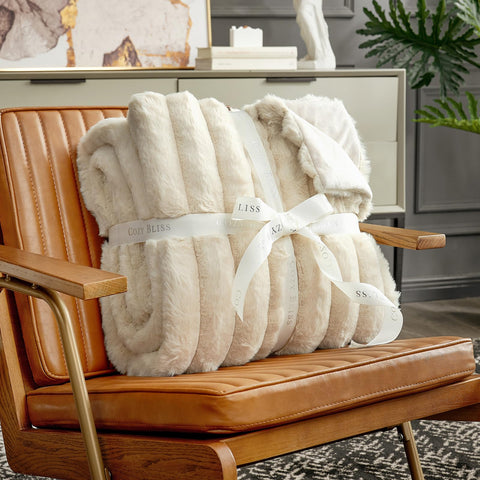 Cozy Bliss faux fur throw draped over an armchair