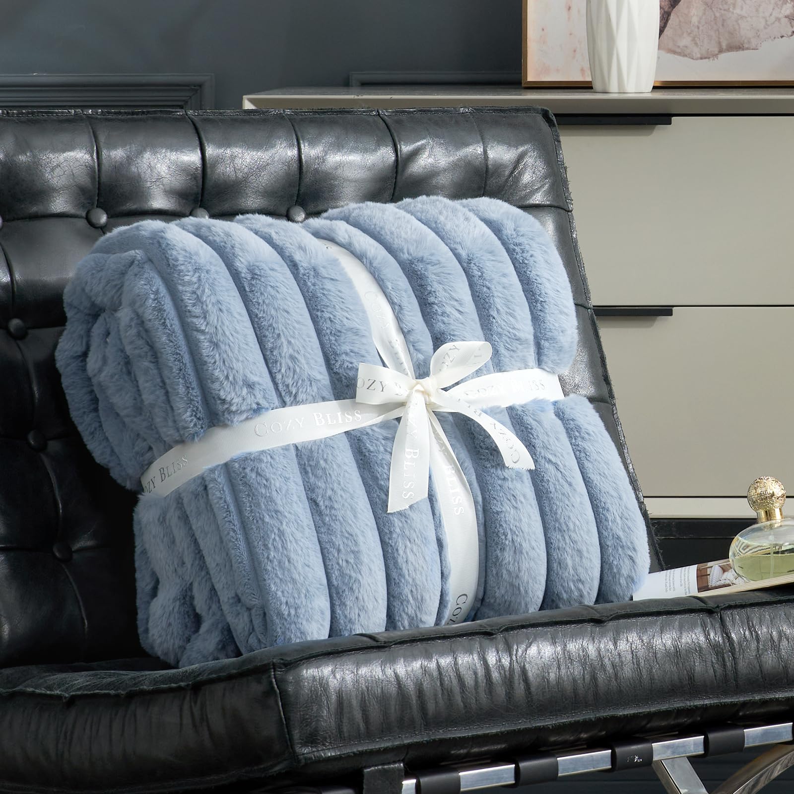 Cozy Bliss faux fur throw draped on bed creates inviting textures in blue