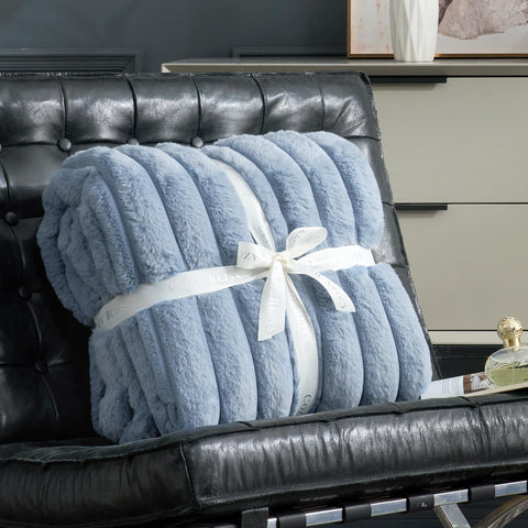 Cozy Bliss faux fur throw draped on bed creates inviting textures in blue