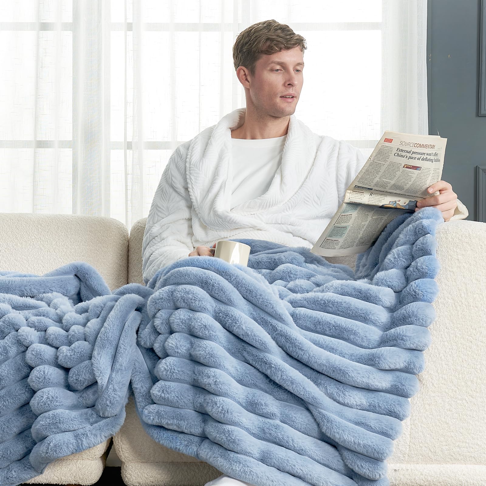 Cozy Bliss faux fur throw in light blue accentuates calm bedroom vibes