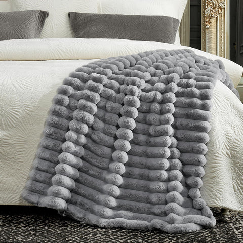Cozy Bliss faux fur throw draped over armchair for cozy comfort