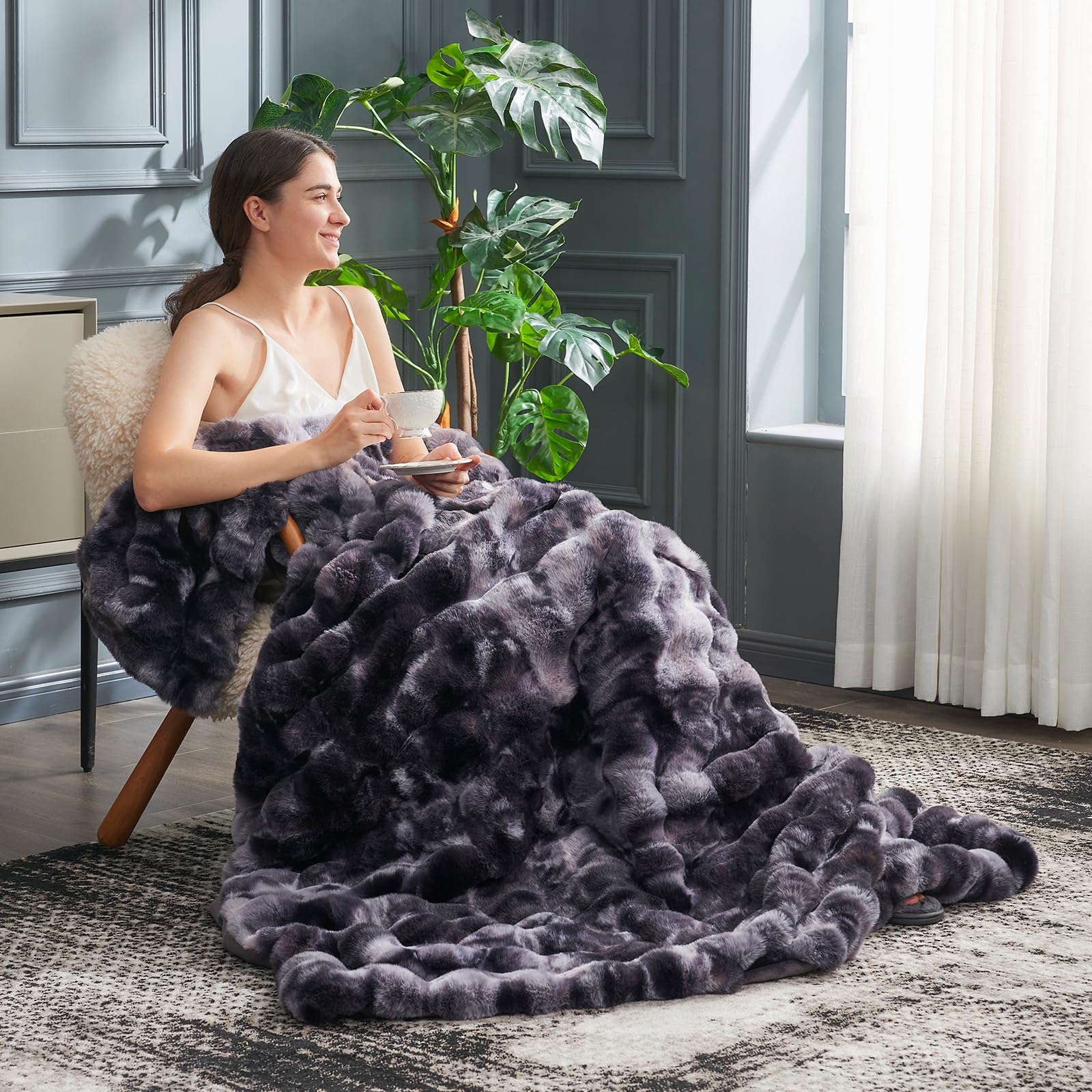 Cozy Bliss faux fur throw with tie-dye black pattern enhances room style.