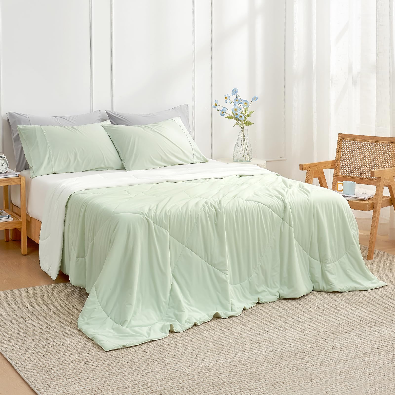 Cozy Bliss light mint green cream blanket draped on bed for summer comfort