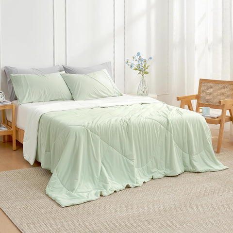 Cozy Bliss light mint green cream blanket draped on bed for summer comfort