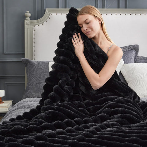 Cozy Bliss plush striped blanket on a bedroom bed adds inviting texture