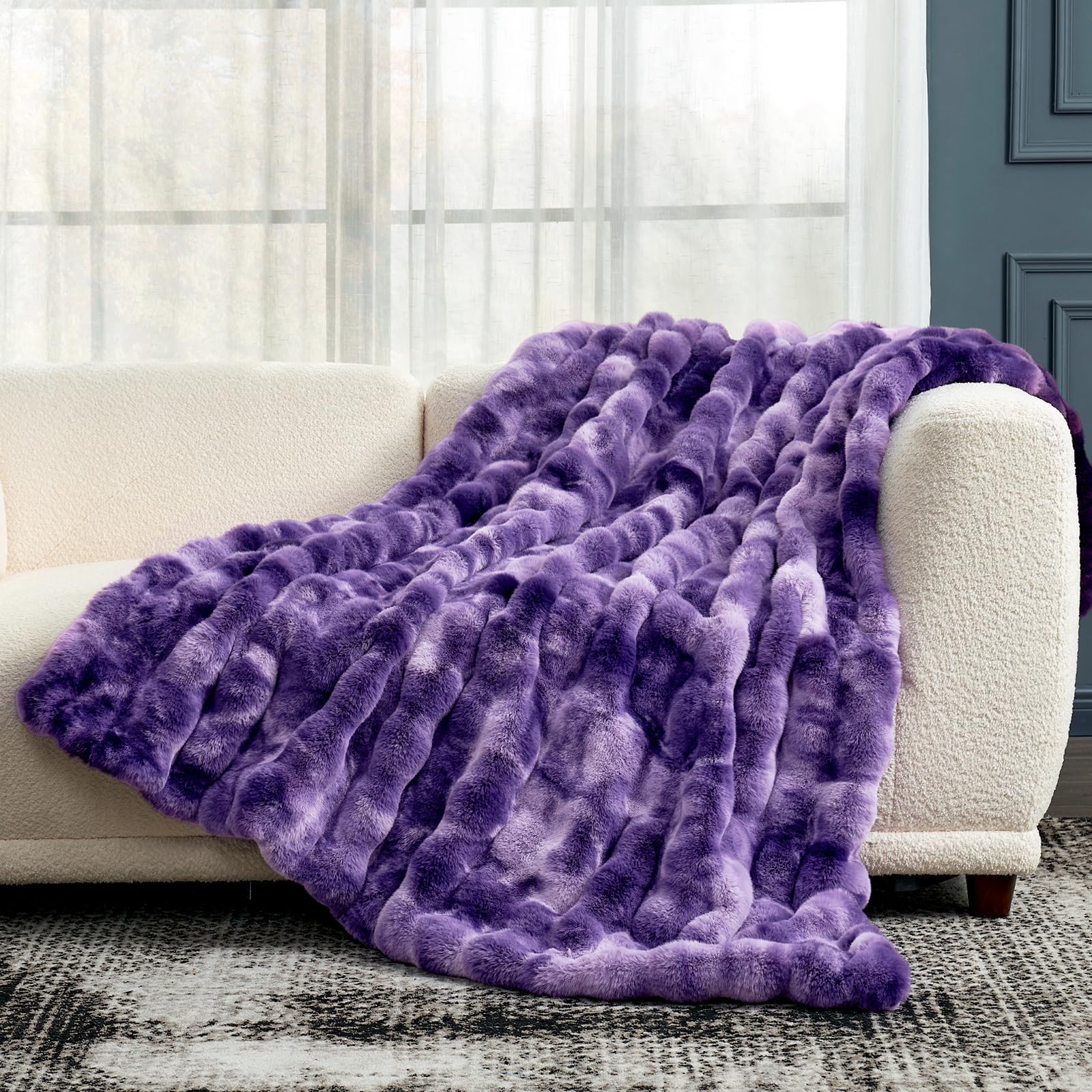 Cozy Bliss tie-dye purple throw on sofa enhances living room ambiance.