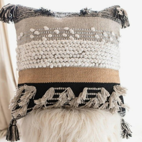 Edges feature decorative tufted tassels for warm farmhouse style