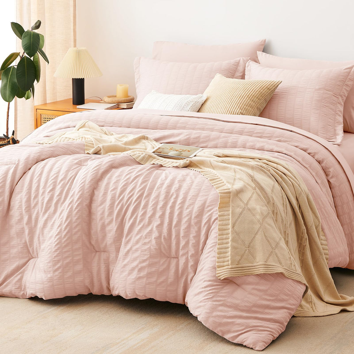 CozyLux queen comforter set in blush seersucker on a bed for a cozy upgrade