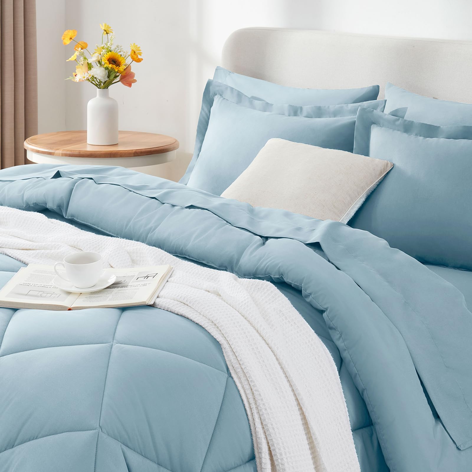 CozyLux Queen Comforter Set light blue vacuum-sealed packaging for compact shipping.