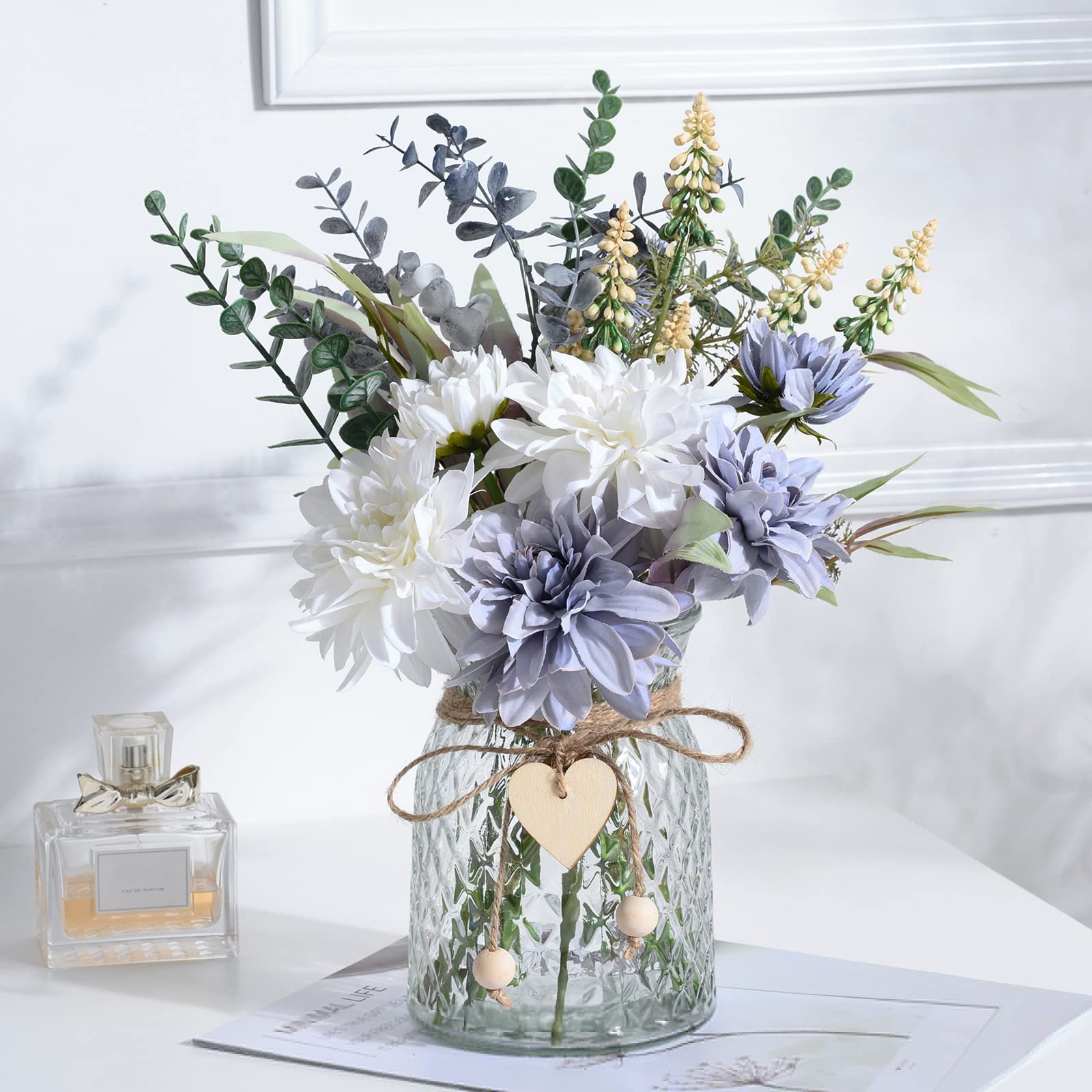 COZZI CODI fake blue flowers bouquet in a glass vase enhances living room decor.
