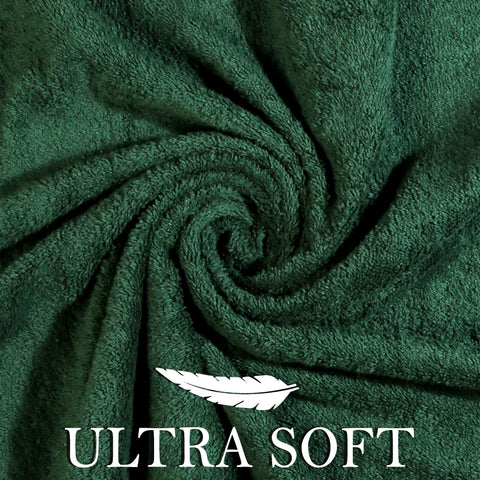 Hotel-style towels complement modern bathroom decor with forest green.
