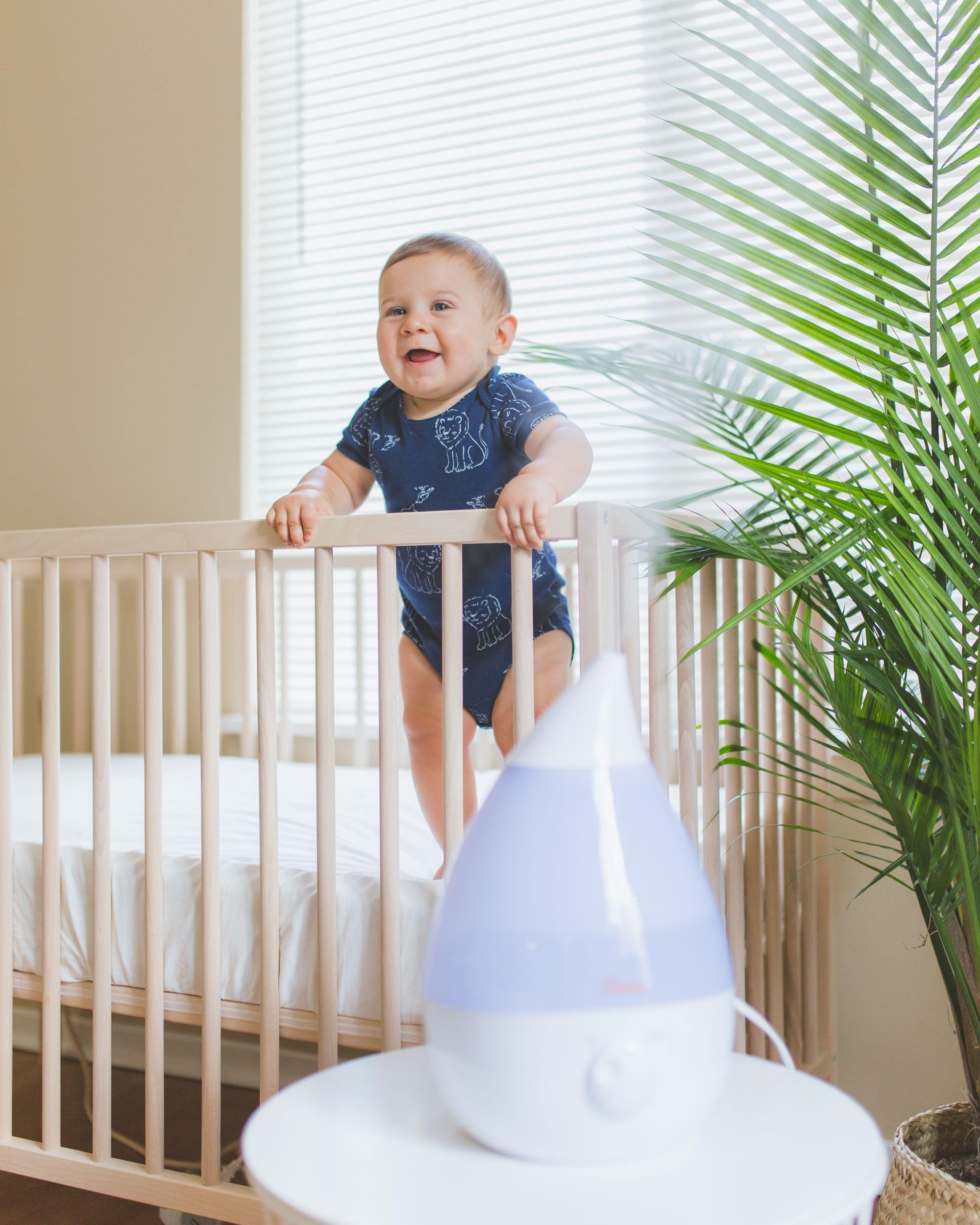 Crane Drop Shape humidifier being filled with water for easy setup.