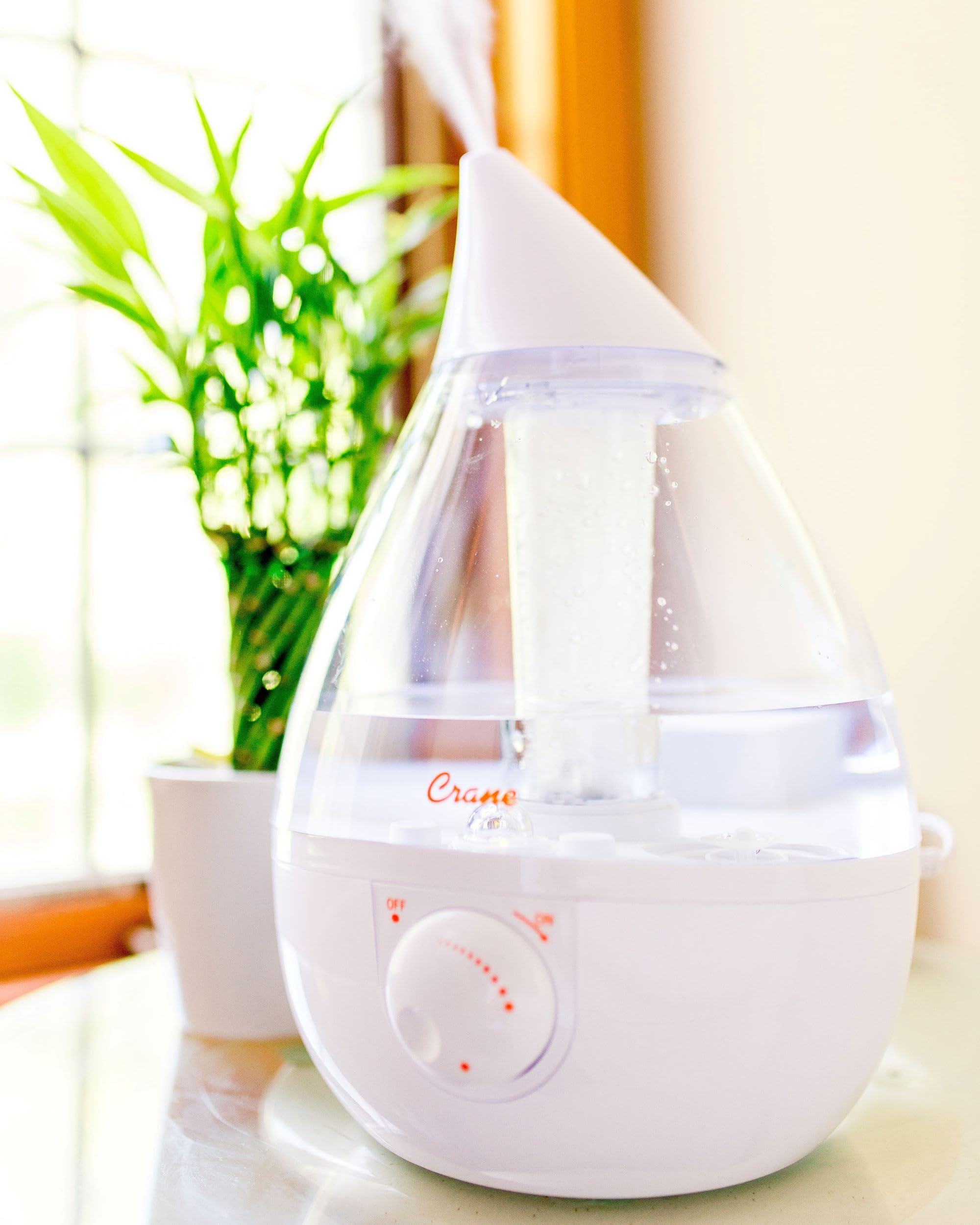 Crane humidifier with night light aiding bedtime routine.