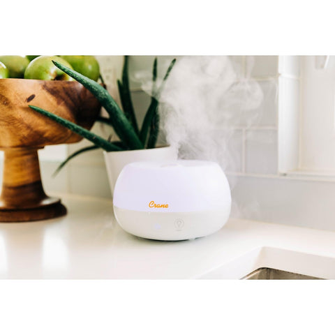 Crane white humidifier with portable design for on-the-go hydration.