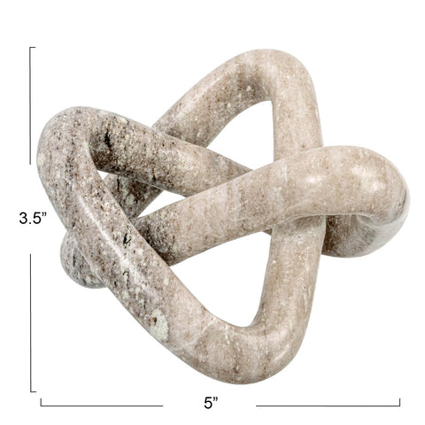 Creative Co-Op beige marble link knot displayed on shelf elevates space