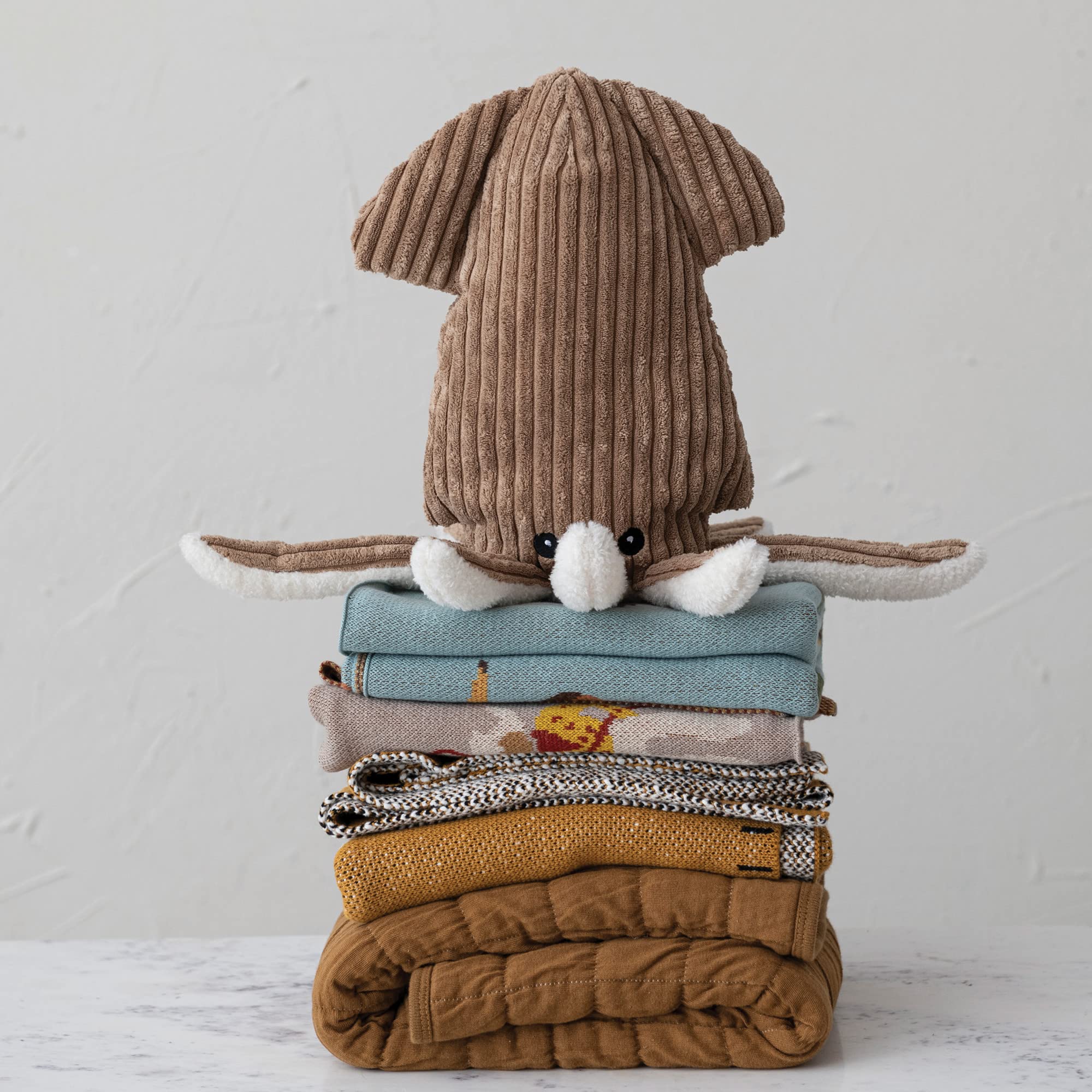 Creative Co-Op multicolor crib decor blanket adds bright nursery charm.