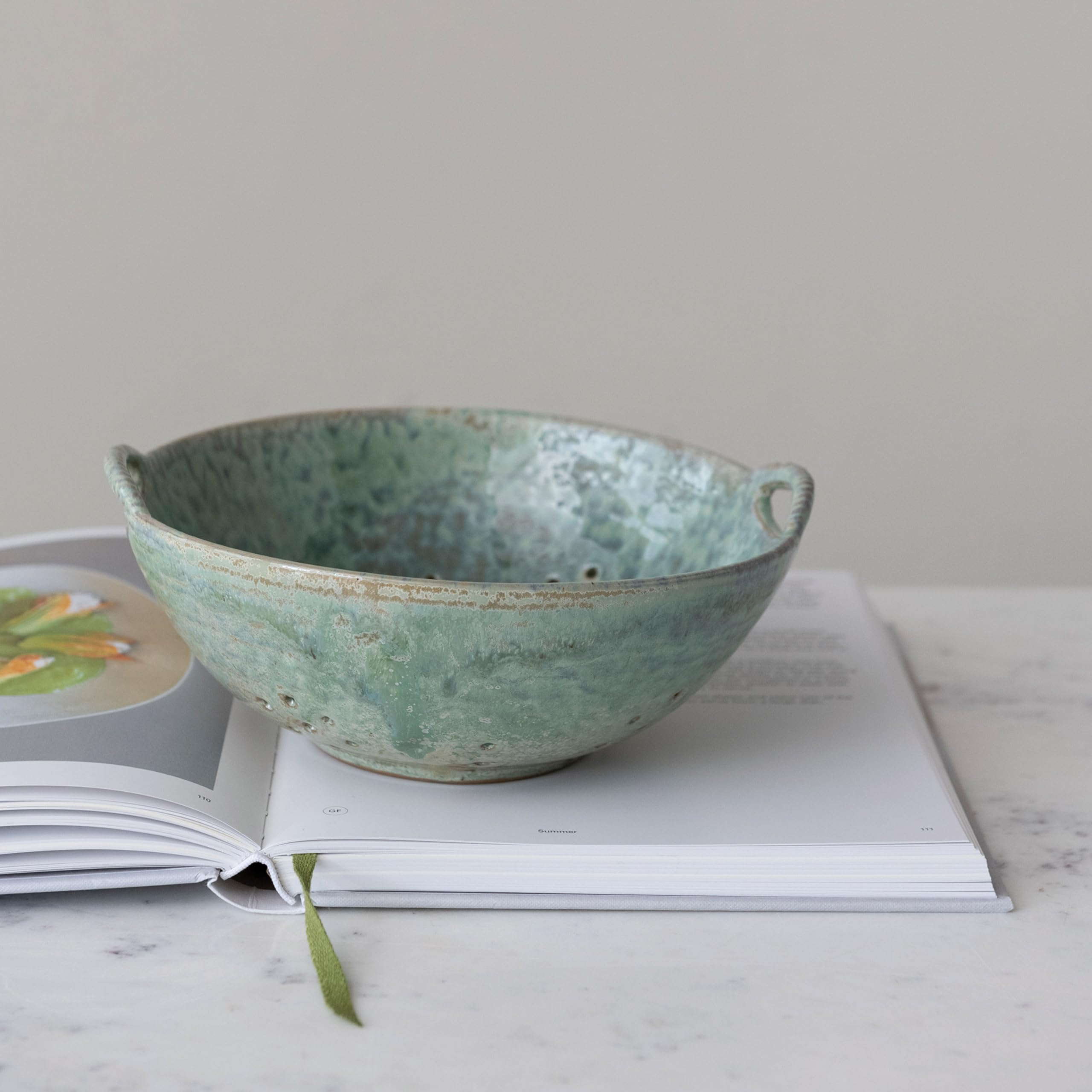 Creative Co-Op berry bowl close-up shows aqua reactive glaze and rustic texture.