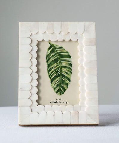 Creative Co-Op white frame on a dresser, ready to elevate display