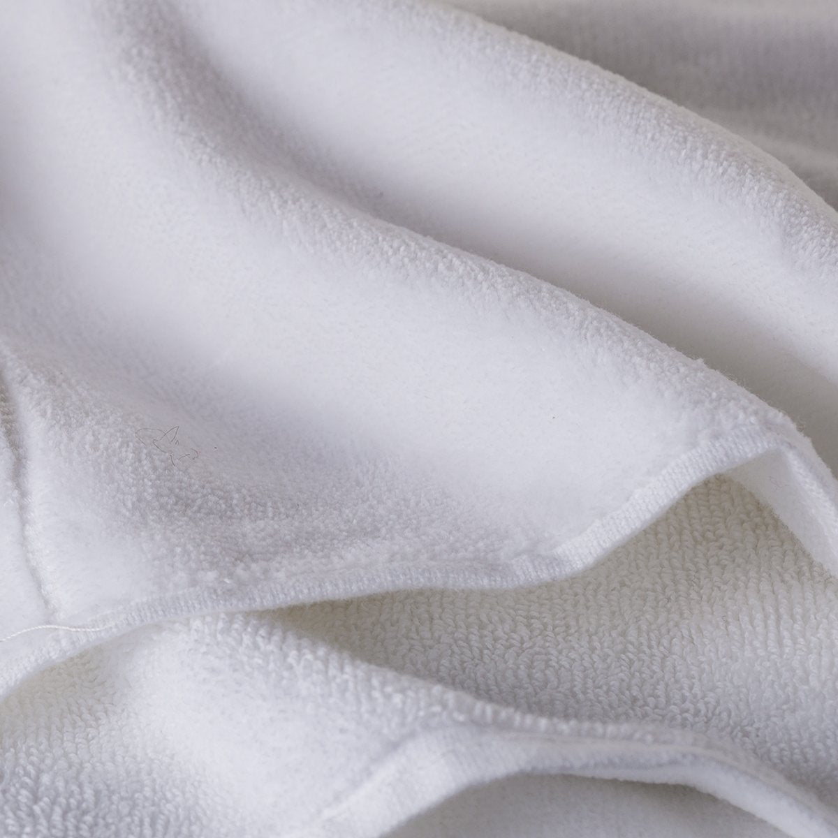 Creative Scents cotton towels on a rack, adds a clean welcoming bathroom vibe