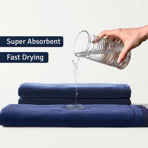 Creative Scents navy towels displayed on a bathroom rack, showcasing soft texture and tidy organization.