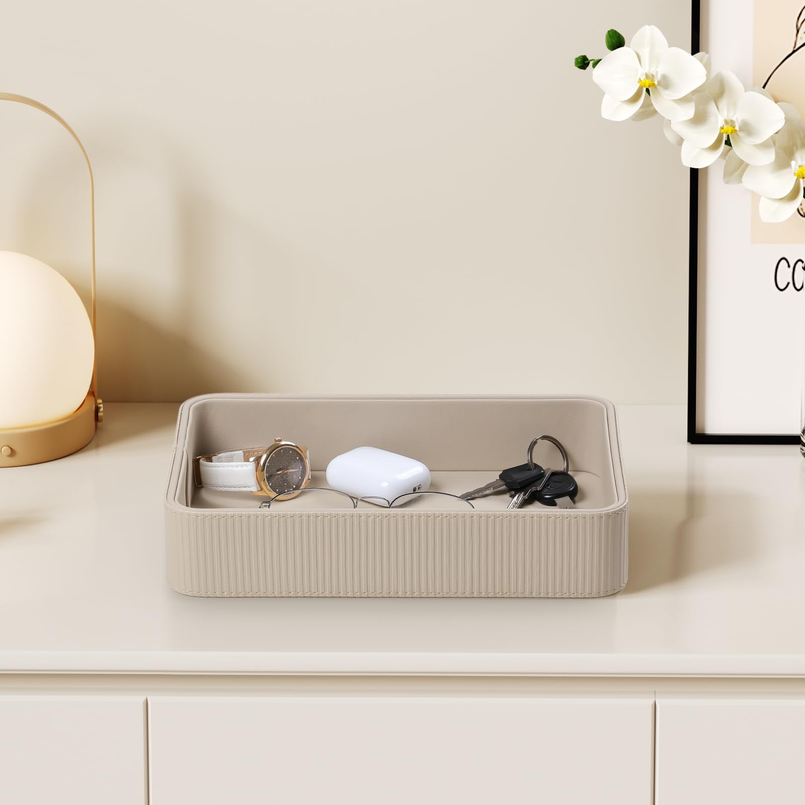 Cretkhp leather valet tray on vanity displays perfumes and jewelry neatly
