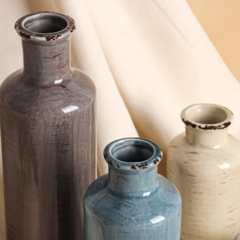 CUCUMI mantel display with three vases for a refined focal point.