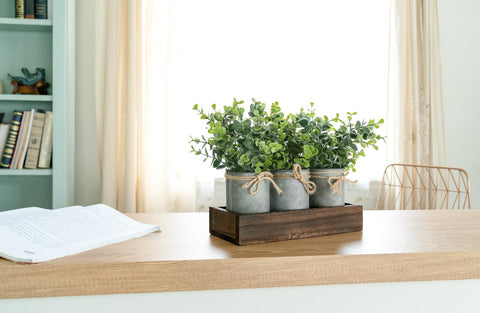 Dahey galvanized pots with eucalyptus arranged together create a stylish table centerpiece