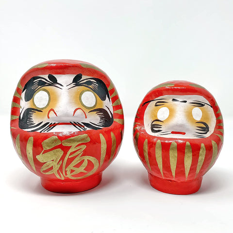 Artisan craftsmanship on a Daimonya Daruma doll with washi paper