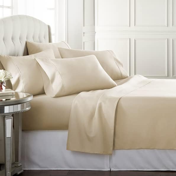 Danjor Linens king-cream fitted sheet on bed demonstrates deep-pocket fit for a secure hold.