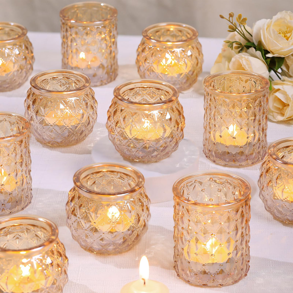 DARJEN gold votive candle holders illuminate wedding tables.