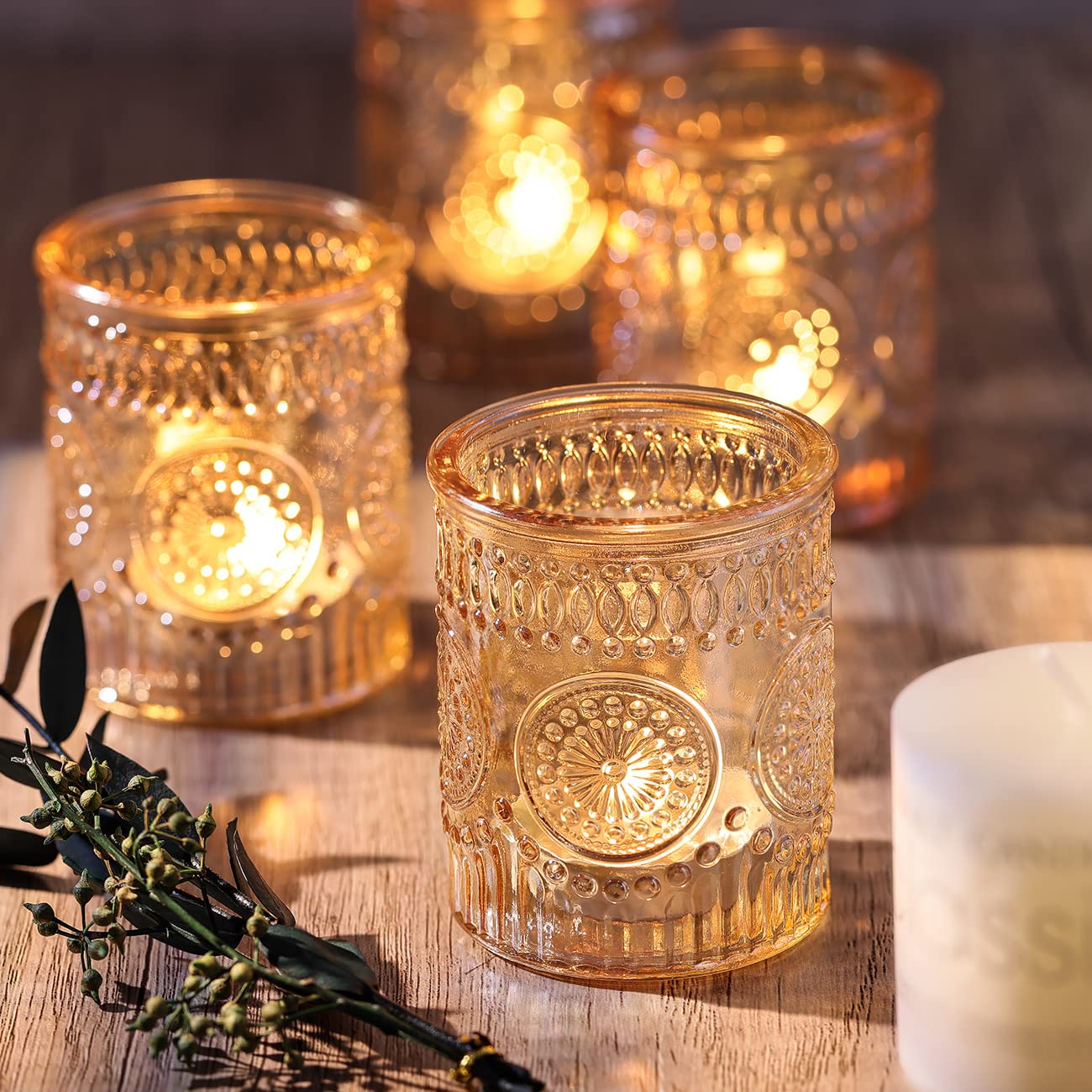 DARJEN wedding centerpieces in gold glass sparkle under ambient lighting.