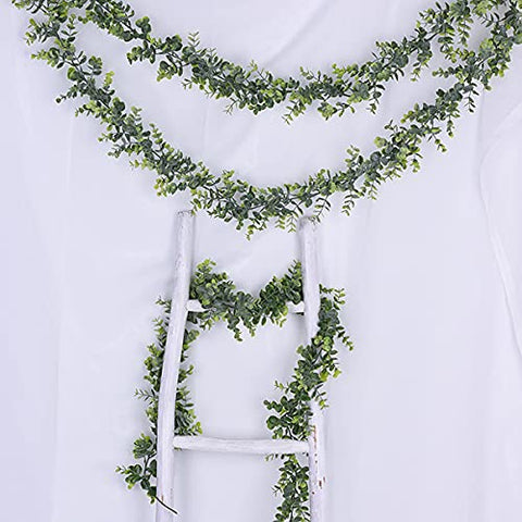 DearHouse garland drapes over table edges with graceful greenery.