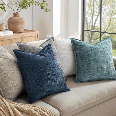 Pillow cover shown on a stylish sofa provides elegant home decor accents.
