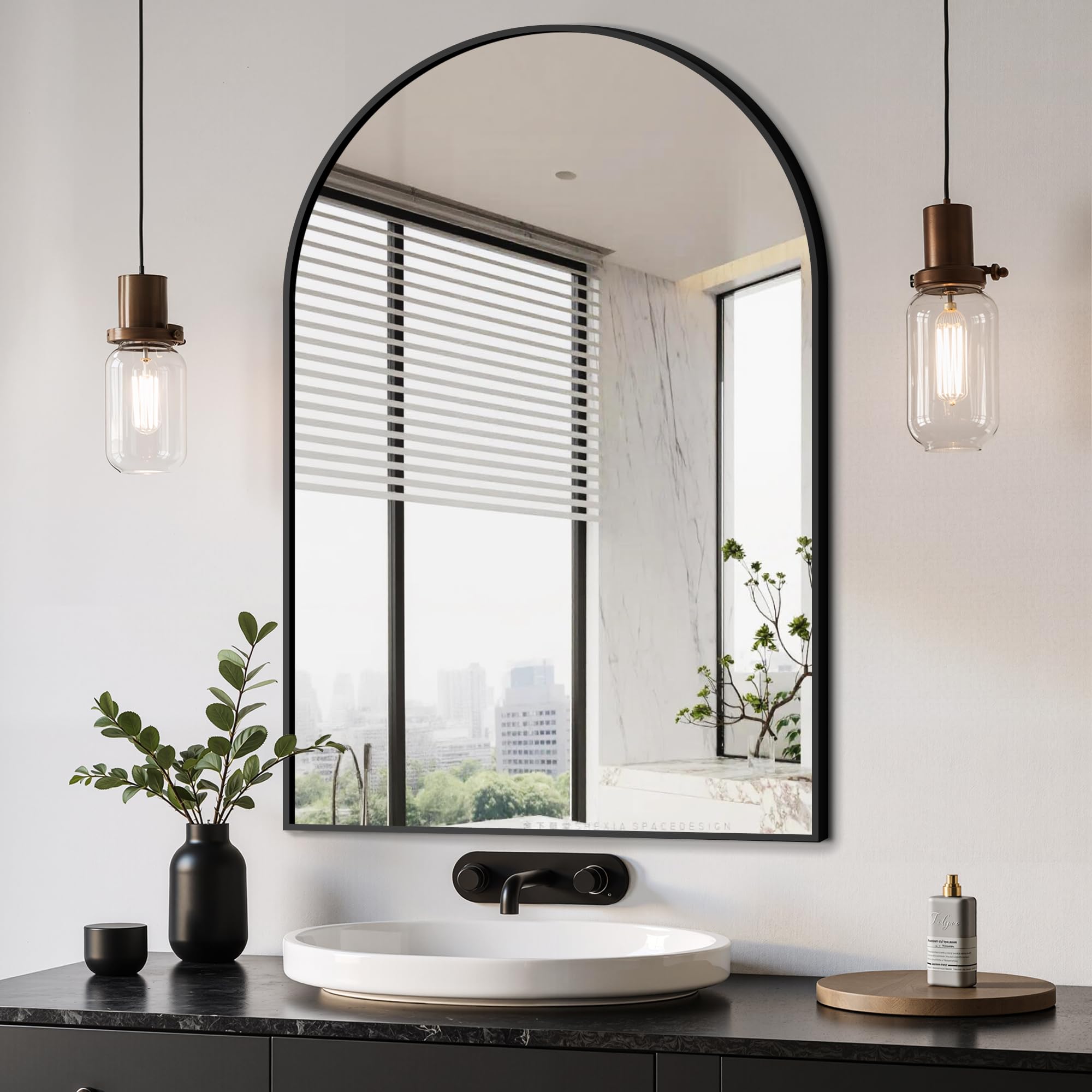 Delma arched mirror in black, wall-mounted to brighten and visually expand spaces.