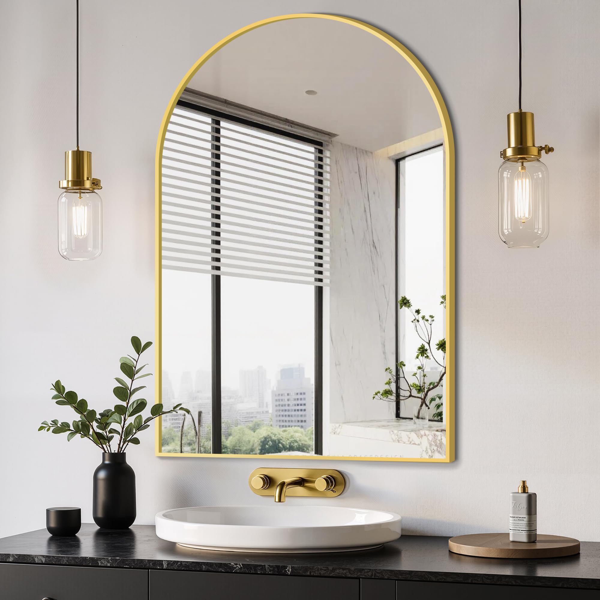 Delma arched mirror with a brushed gold frame adds height and brightness.