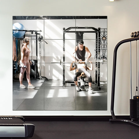 Delma frameless mirror tiles mounted on wall for bright reflections.