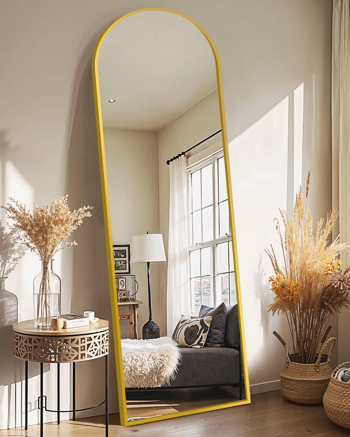 Delma full length mirror with gold arch frame reflecting daylight in a stylish bedroom