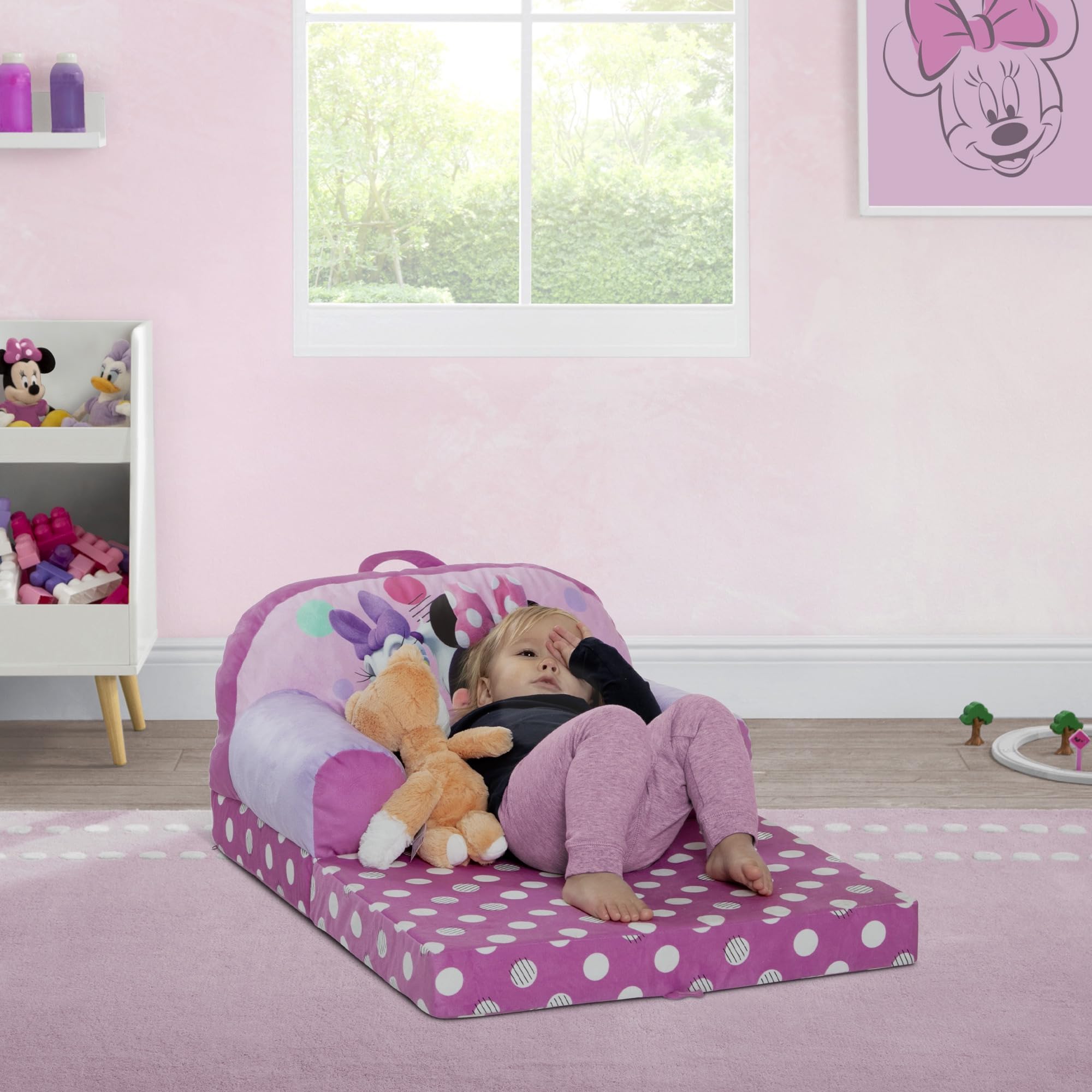 Delta Children Minnie Mouse Cozee Buddy Flip-Out Chair pink converts to a sleeper for naps.