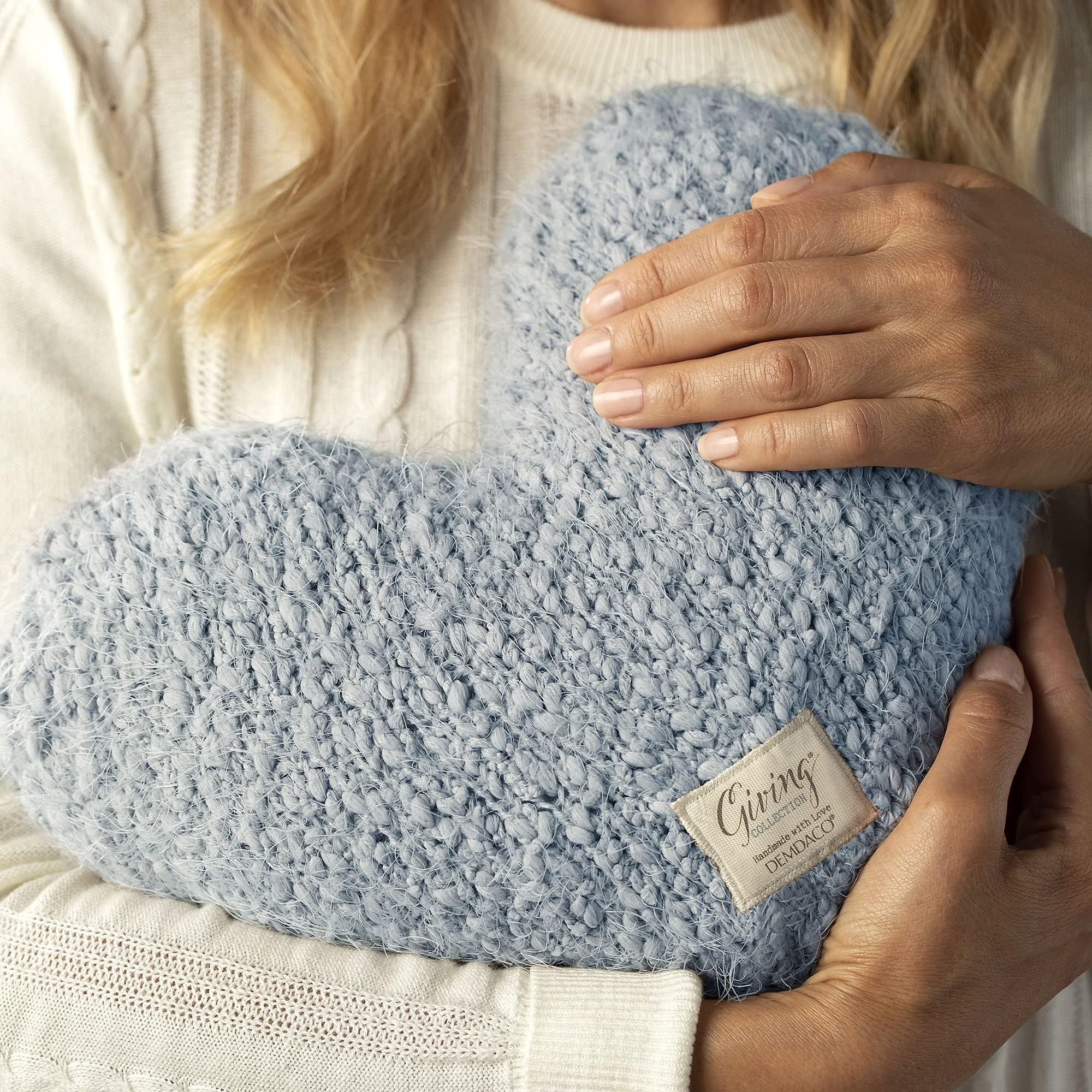 Artisan craftsmanship and soft fabric elevate tactile appeal of the weighted heart pillow.