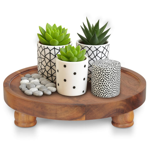 Demigo 10-inch acacia round tray used as a stylish countertop display stand.