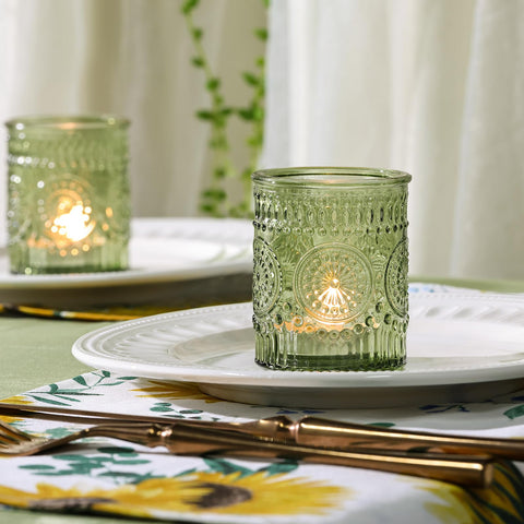 DEVI olive-green glass tea-light holder elevates party ambience.