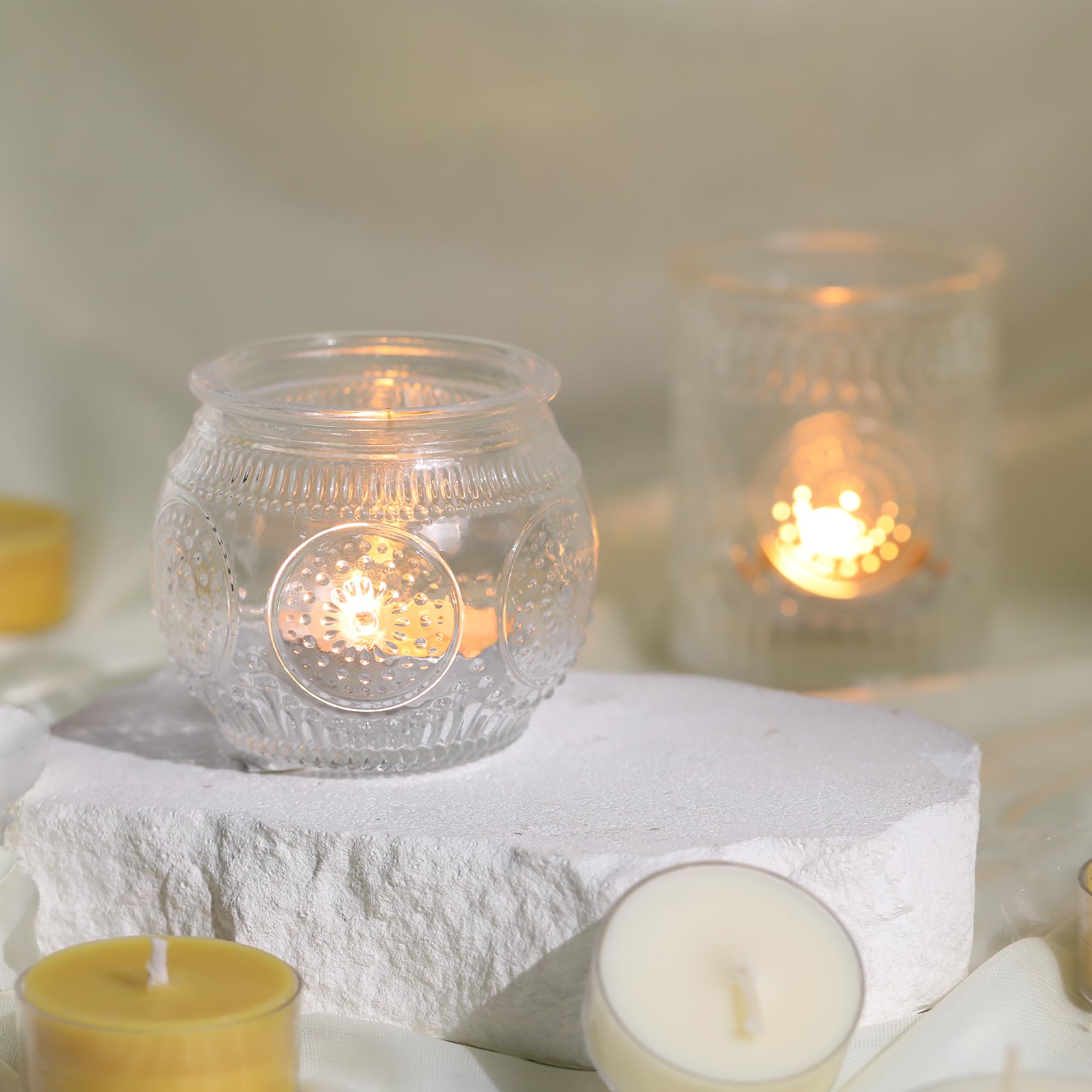 DEVI sunflower-embossed votive holder adds vintage charm.