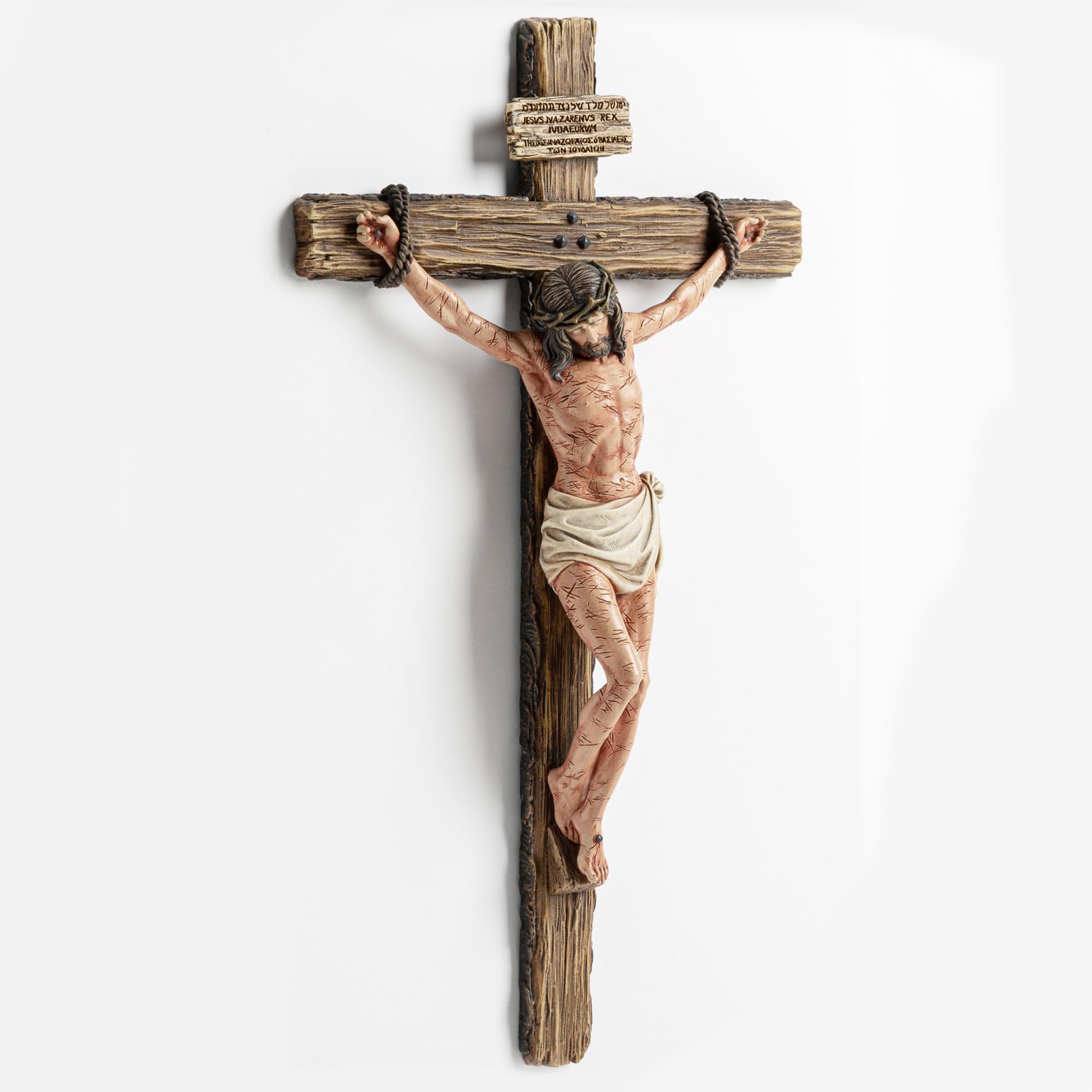 DevotedWalls crucifix with multilingual inscription enhances sacred authenticity.