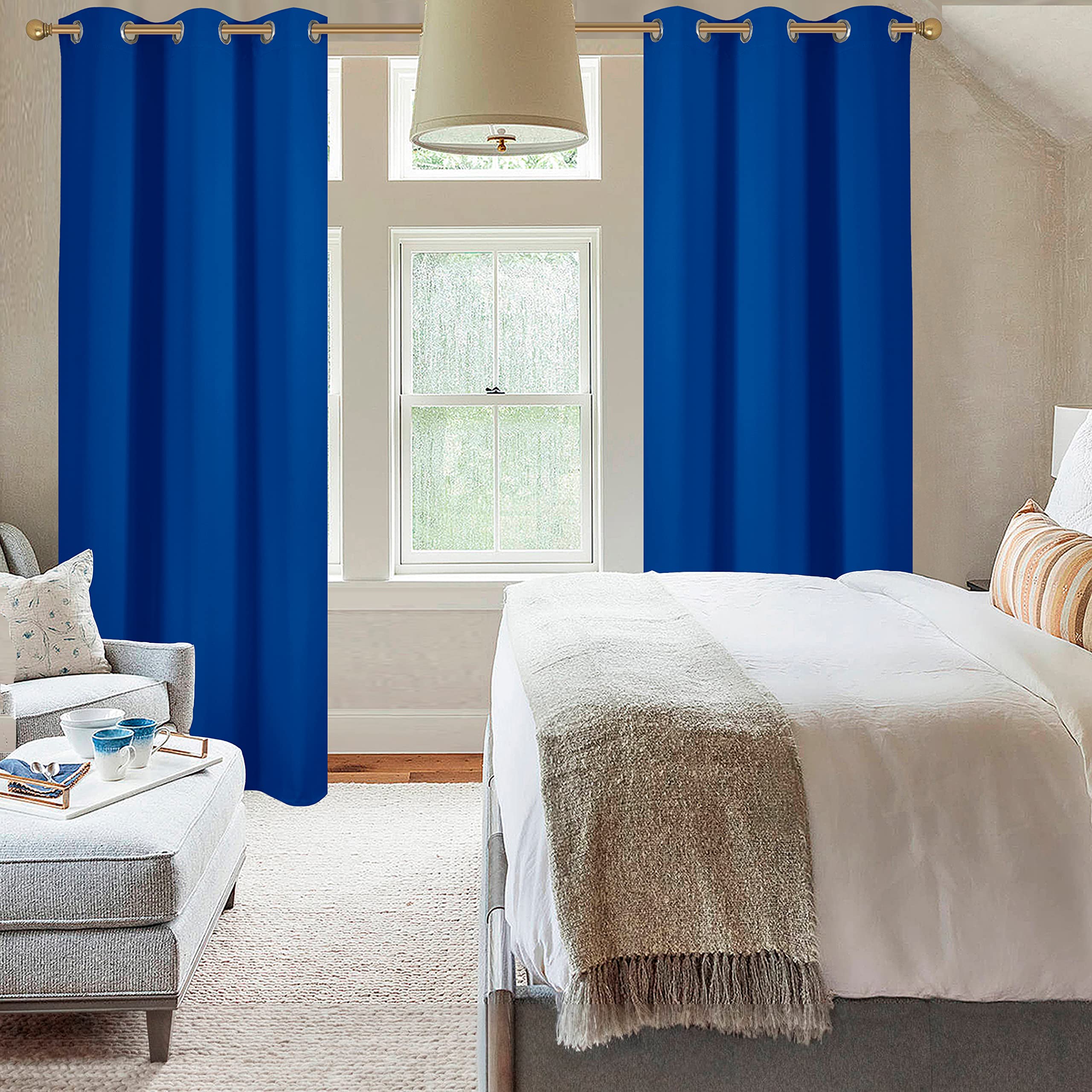 Diraysid Royal Blue curtains in a bedroom create a darker, calmer space.