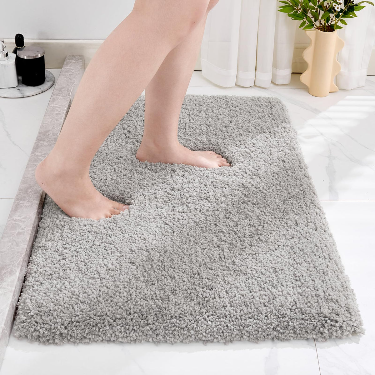 Disolla grey bathroom rug 20x32 provides soft underfoot comfort.