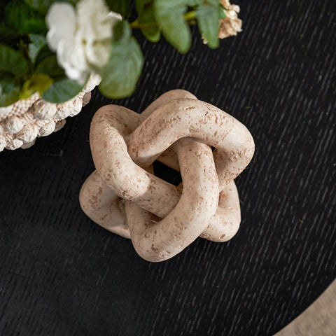 DN DECONATION 3-link knot decor beige travertine on bedroom nightstand, calm accent