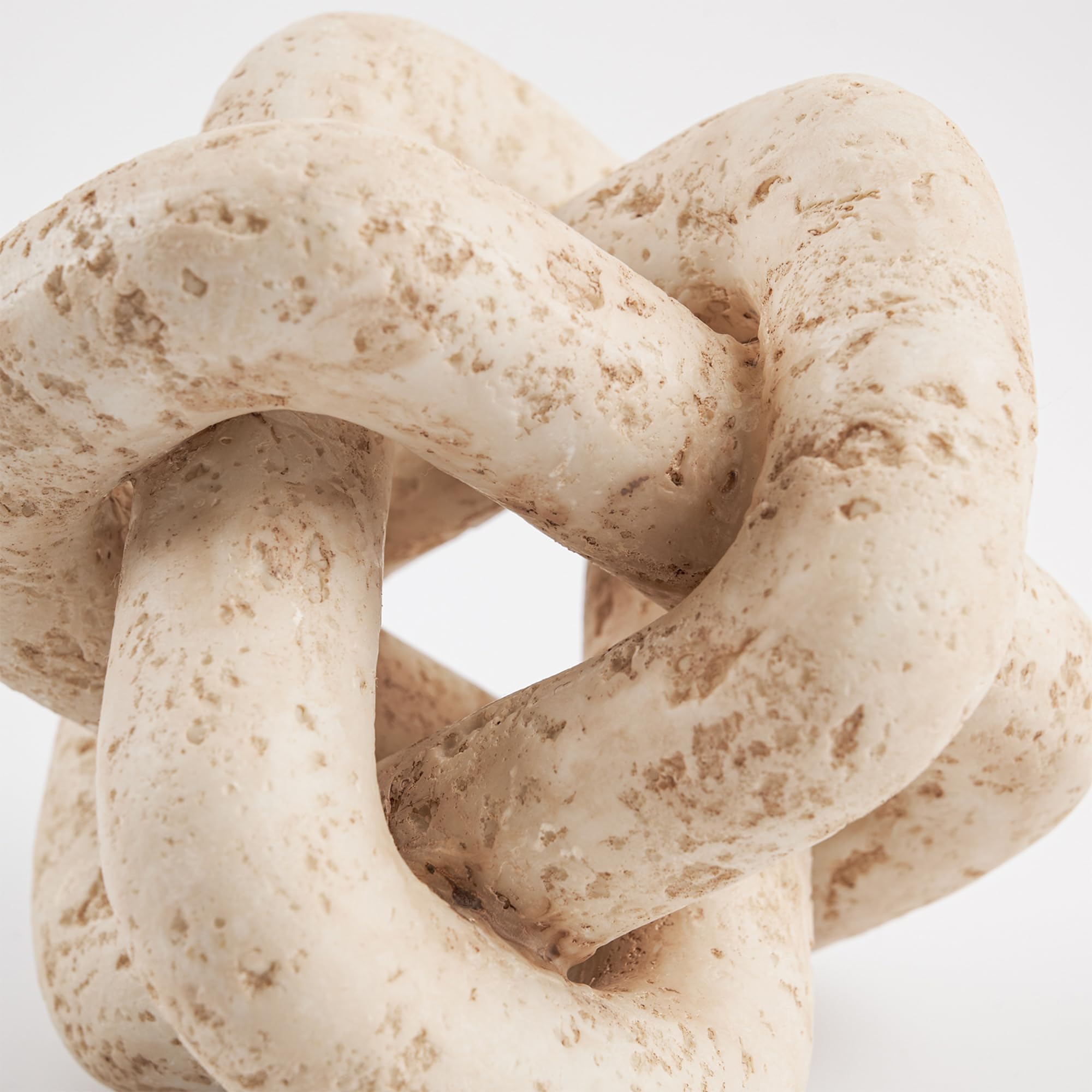 DN DECONATION 3-link knot decor beige travertine on living room console, refined detail
